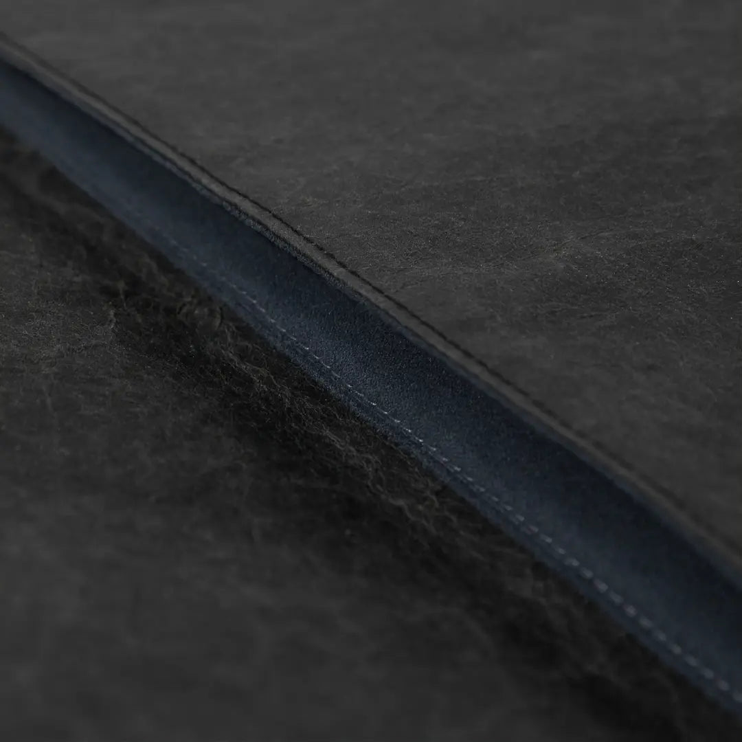 opening-detail.jpg
Close-up of the opening and construction of a black washable paper laptop sleeve.