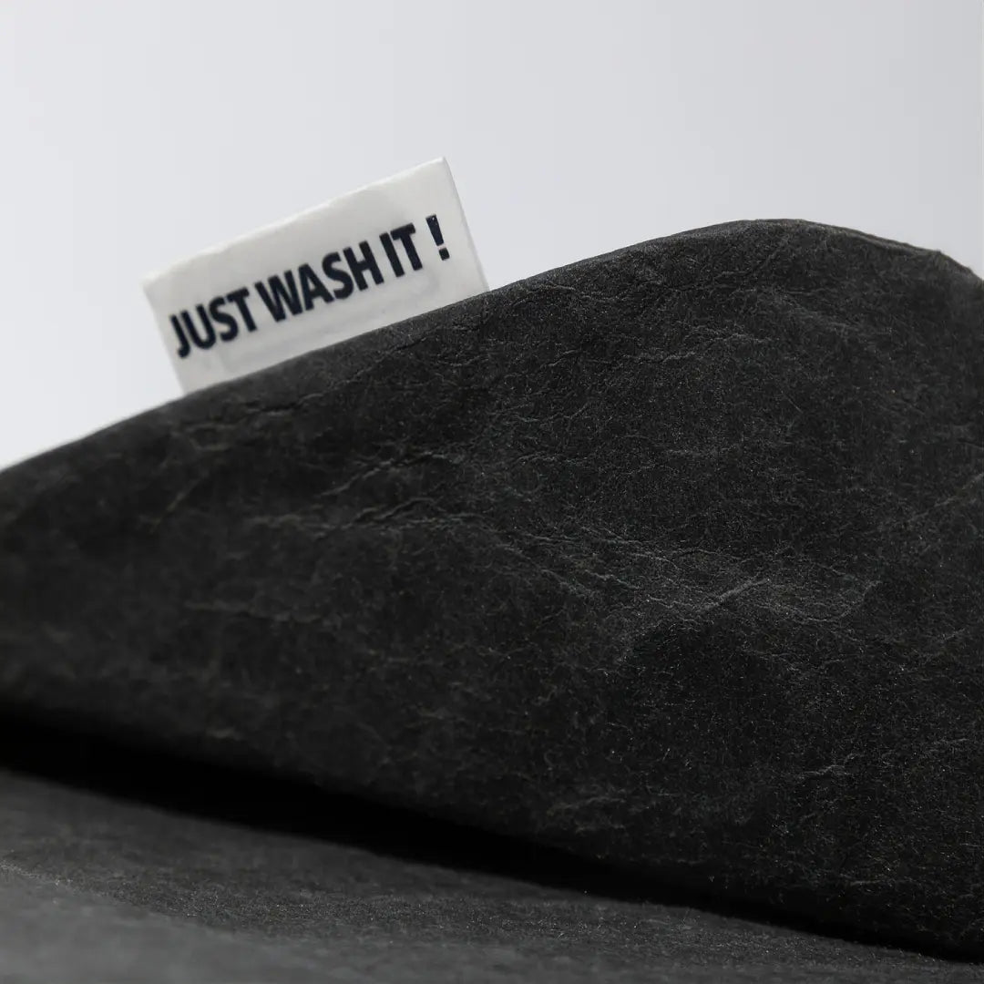 Close-up of the natural paper texture on a black washable paper laptop sleeve