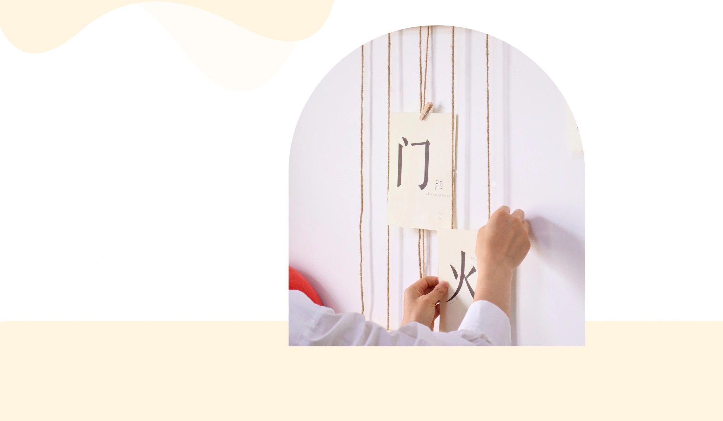 Chinese character cards clipped and displayed on a wall in a home setting.