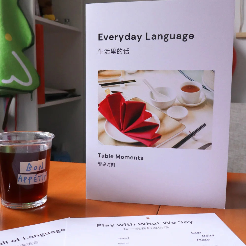 A paper-based Everyday Language system showing English expressions arranged on a table.