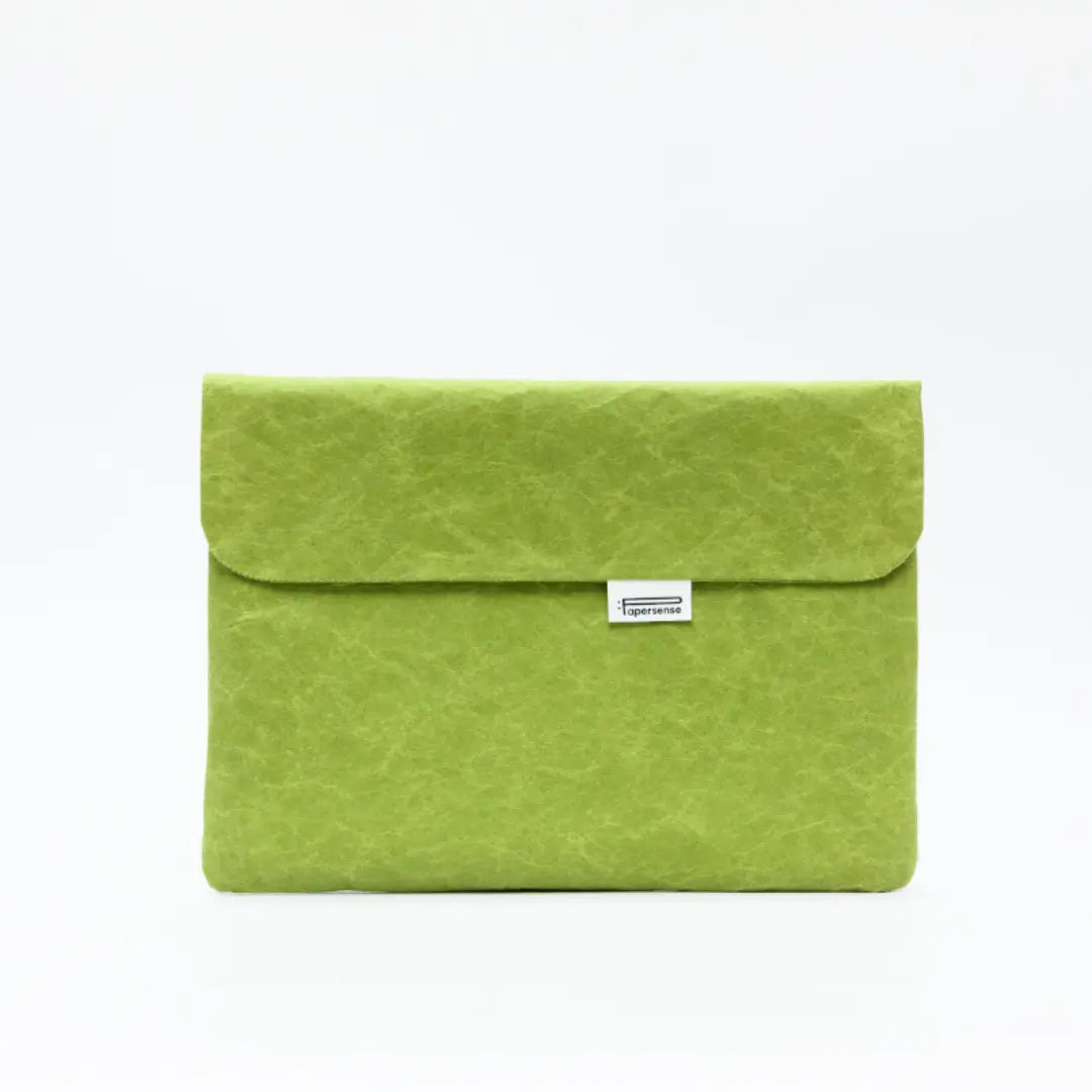 Green washable paper laptop sleeve with a natural paper texture.