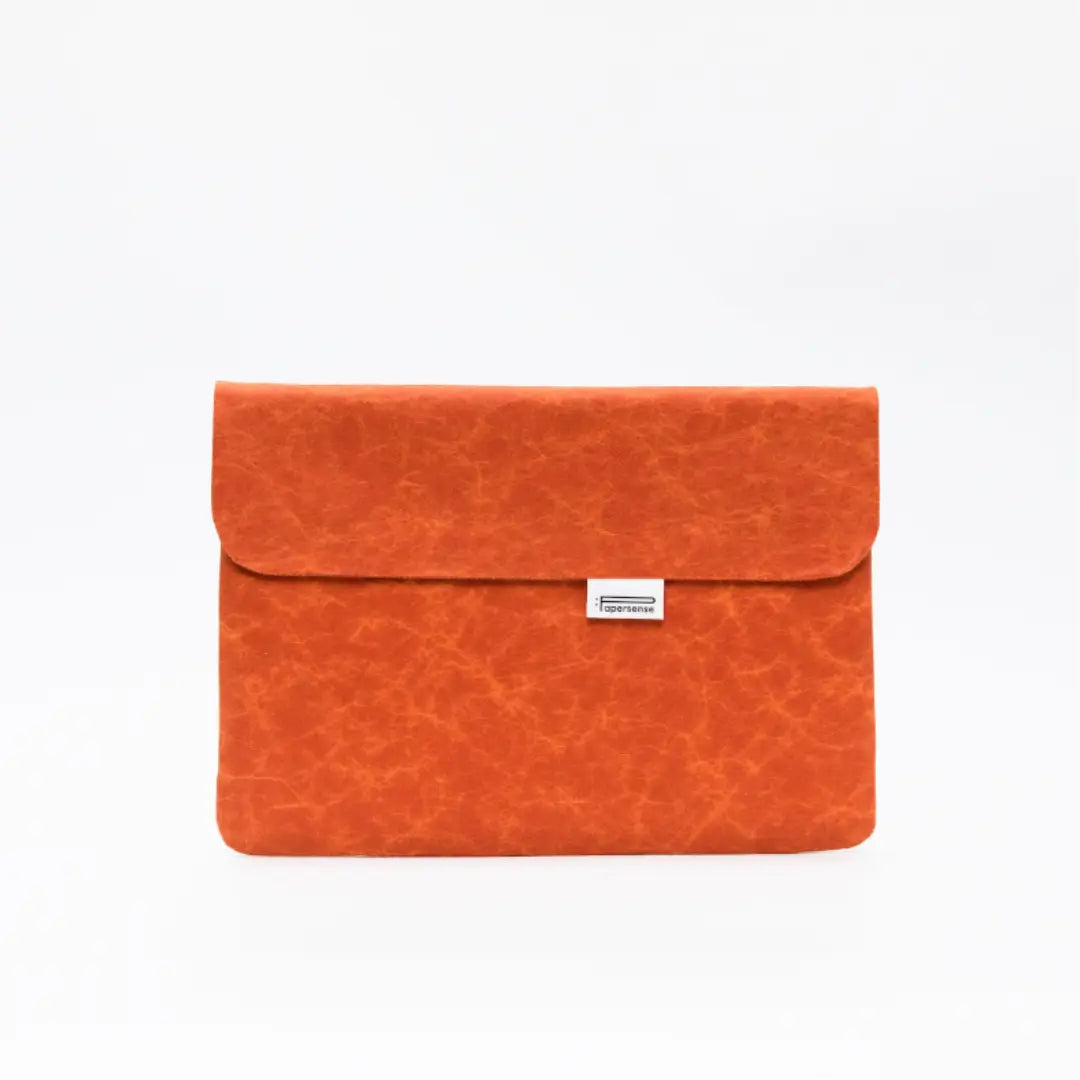 Orange washable paper laptop sleeve with a natural paper texture