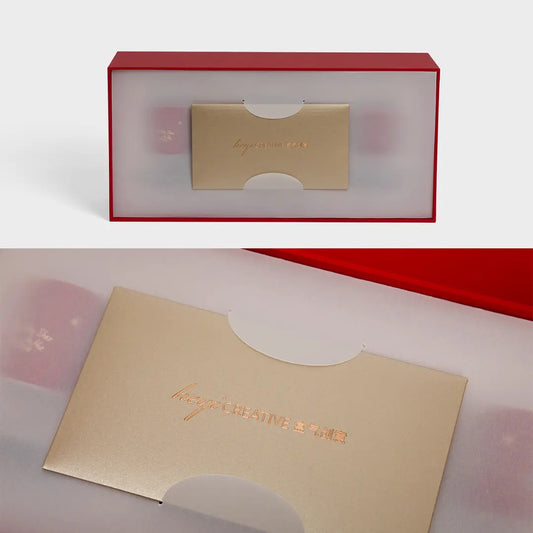 Translucent paper card holder integrated into luxury gift packaging with gold card detail.