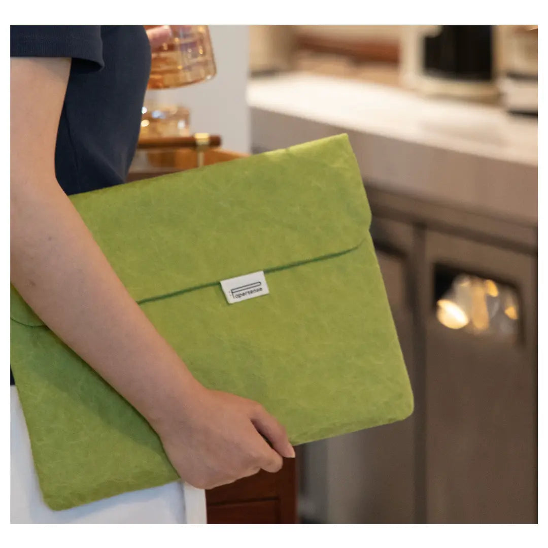 Green washable paper laptop sleeve for branded merchandise.