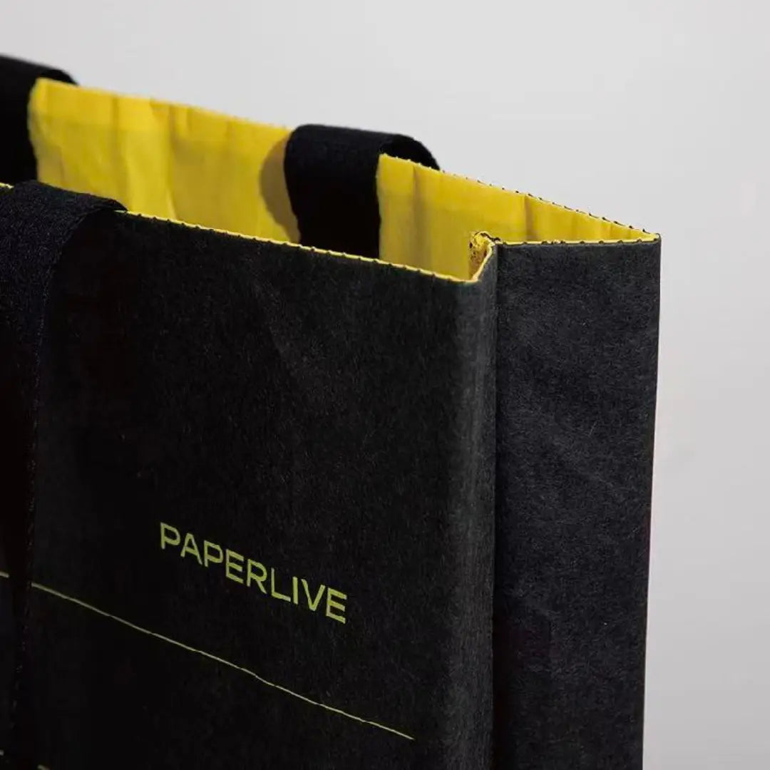 Close-up of washable paper tote bag top and handle details.